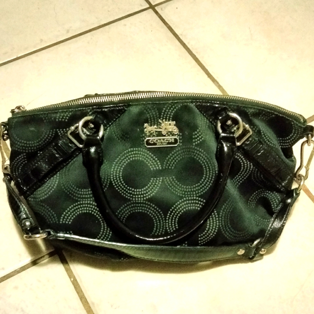 Coach bag black over the shoulder and handheld.